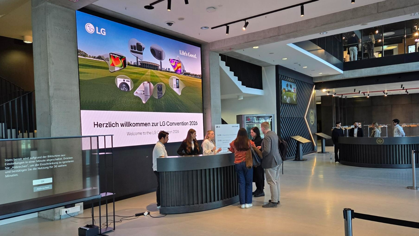 Attendees ask for assistance at the information desk at LG Convention 2026 in Frankfurt.
