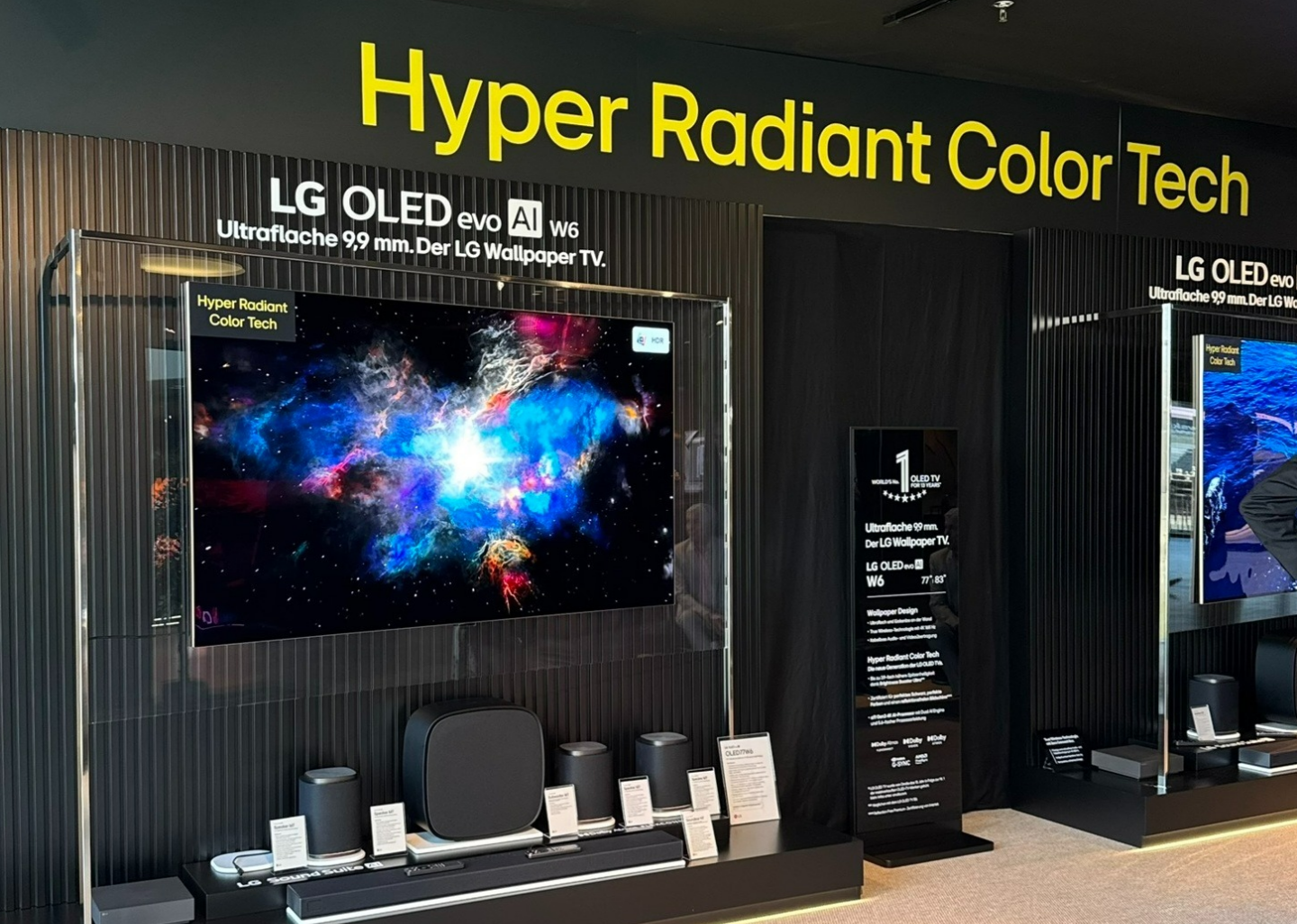 An LG OLED evo W6 Wallpaper TV is mounted to the wall under the title of "Hyper Radiant Color Tech."