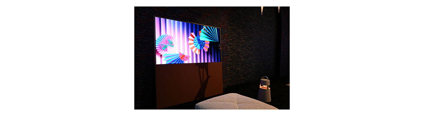 LG OLED Objet Collection Easel and LG XBOOM speaker featured in a living room showroom at CES 2023