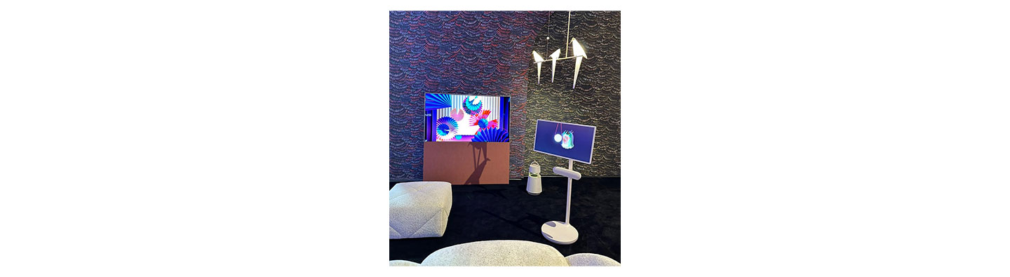 LG StanbyME and LG OLED Objet Collection Easel in a showroom full of sofa cushions and a hanging bird ornament