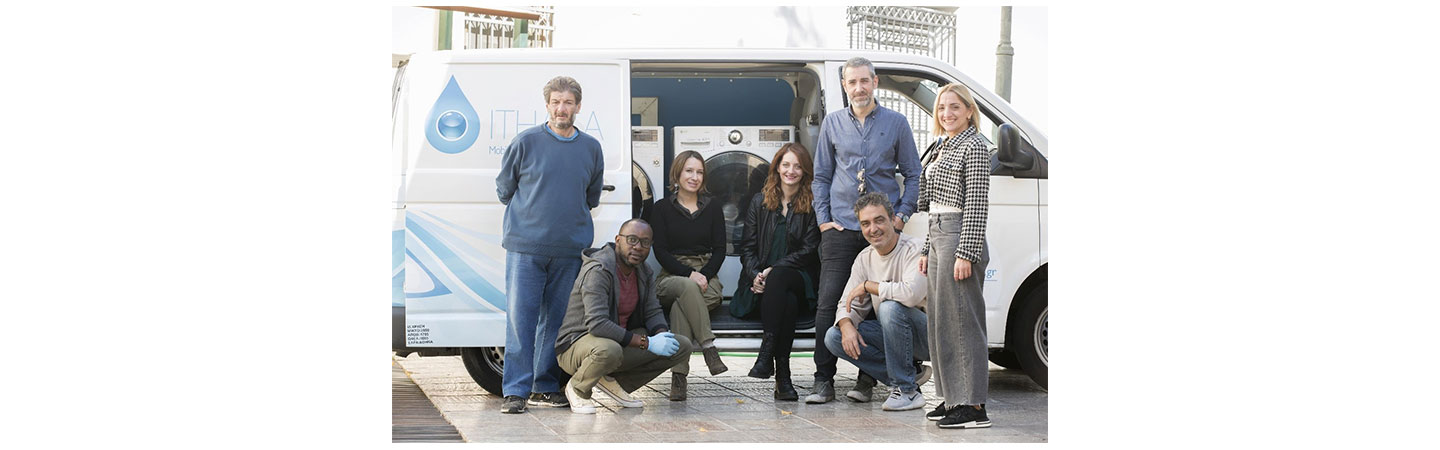 Members of LG Greece and non-profit organization Ithaca with their van that holds two LG washers and dryers to help homeless individuals with their personal hygiene.