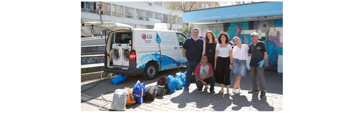 Members of Ithaca, who are making a big difference to those in need, pose next to their van that holds LG washers and dryers with the support of LG Greece.