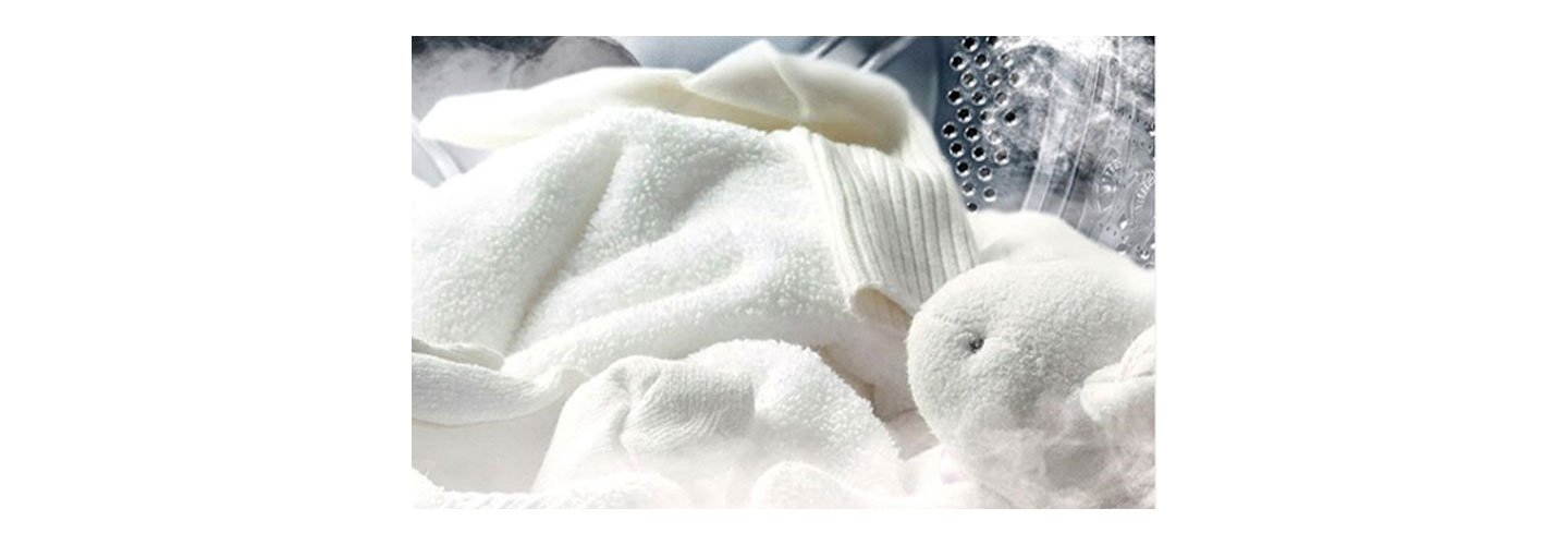 A close-up of soft white clothes being cleaned inside one of LG’s washing machines