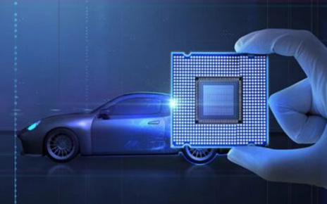 An illustration of a digital chip held by a machine hand and a image of a vehicle in the background