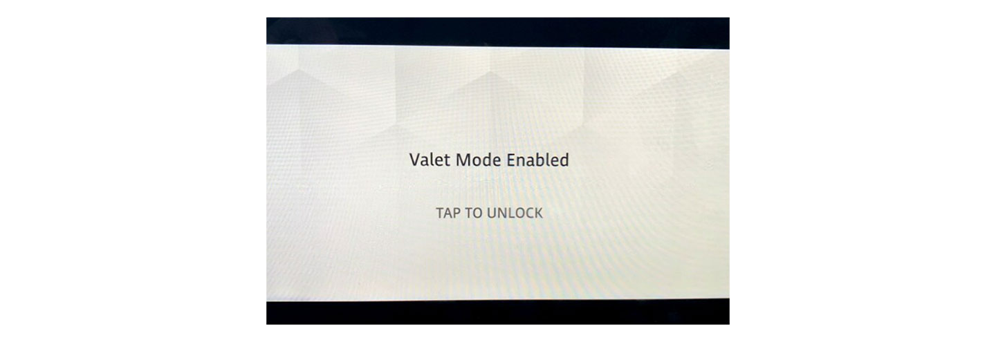 Land Rover Defender’s AVN UI with a phrase 'Valet Mode Enabled' and 'TAP TO UNLOCK' on it