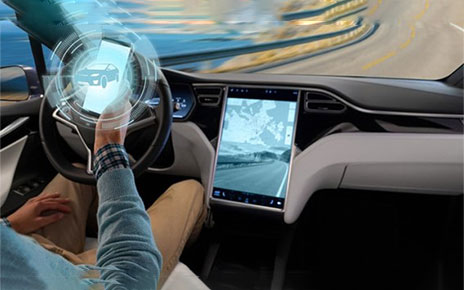 A driver using smartphone to connect to the vehicle's display showing a road ahead