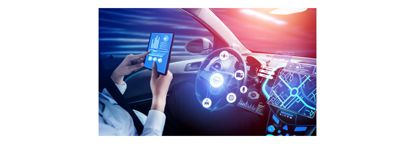 Inside of a car where someone is in the driver's seat looking at a tablet