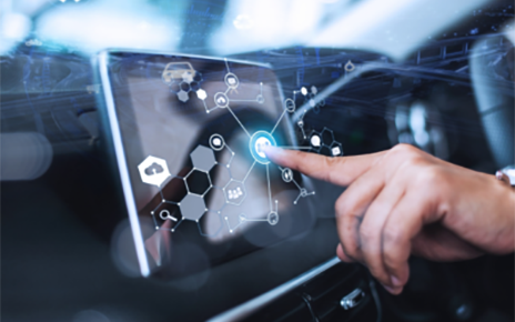 A human hand touching an infotainment display installed in a vehicle