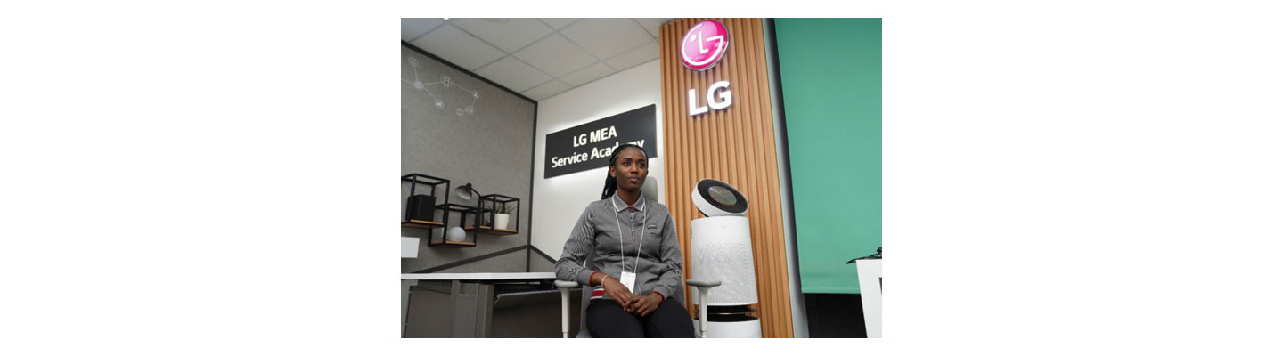 Libanos Tadiyos of LG Electronics Middle East posing for a photo with LG PuriCare next to her