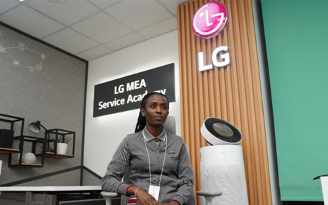 Libanos Tadiyos of LG Electronics Middle East posing for a photo with LG PuriCare next to her