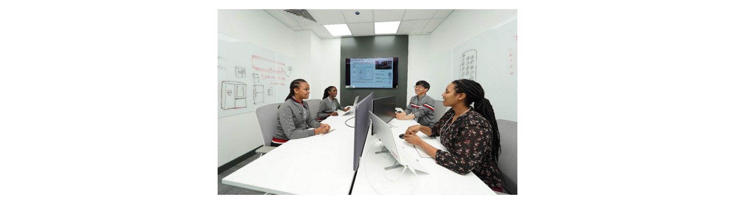 Four people of LG Electronics Middle East having a meeting in a room