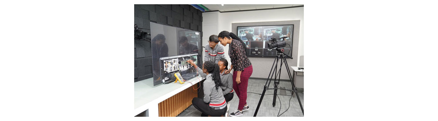 Four people of LG Electronics Middle East inspecting LG TV