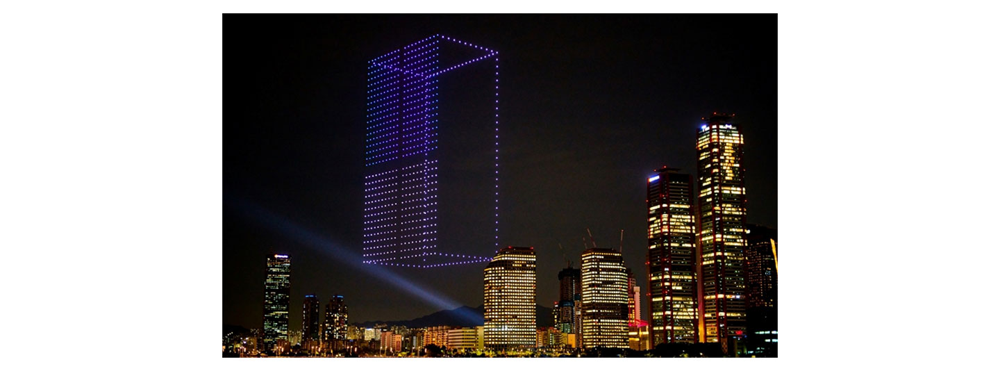 A photo of the LG MoodUP refrigerator made out of 1,000 drones brightening the night sky above Seoul, Korea