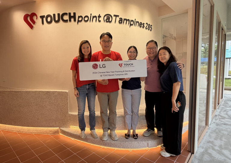 LG Singapore representatives hold a sign in partnership with the TOUCHpoint@Tampines 285 community hub.