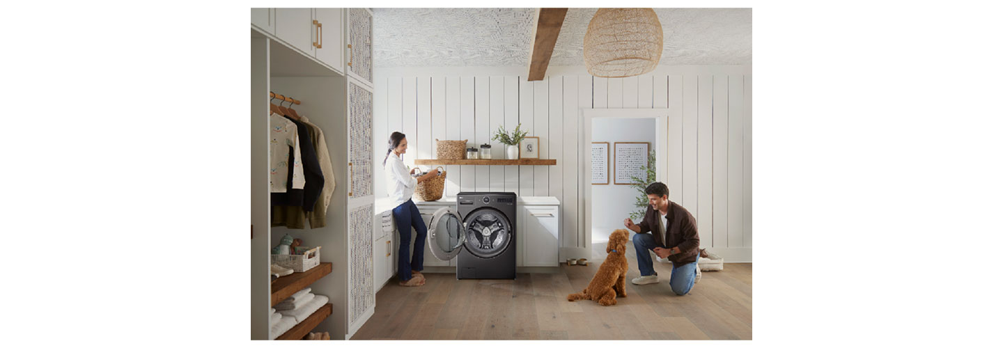 An image of a woman using the LG WashCombo and a man with a dog next to her