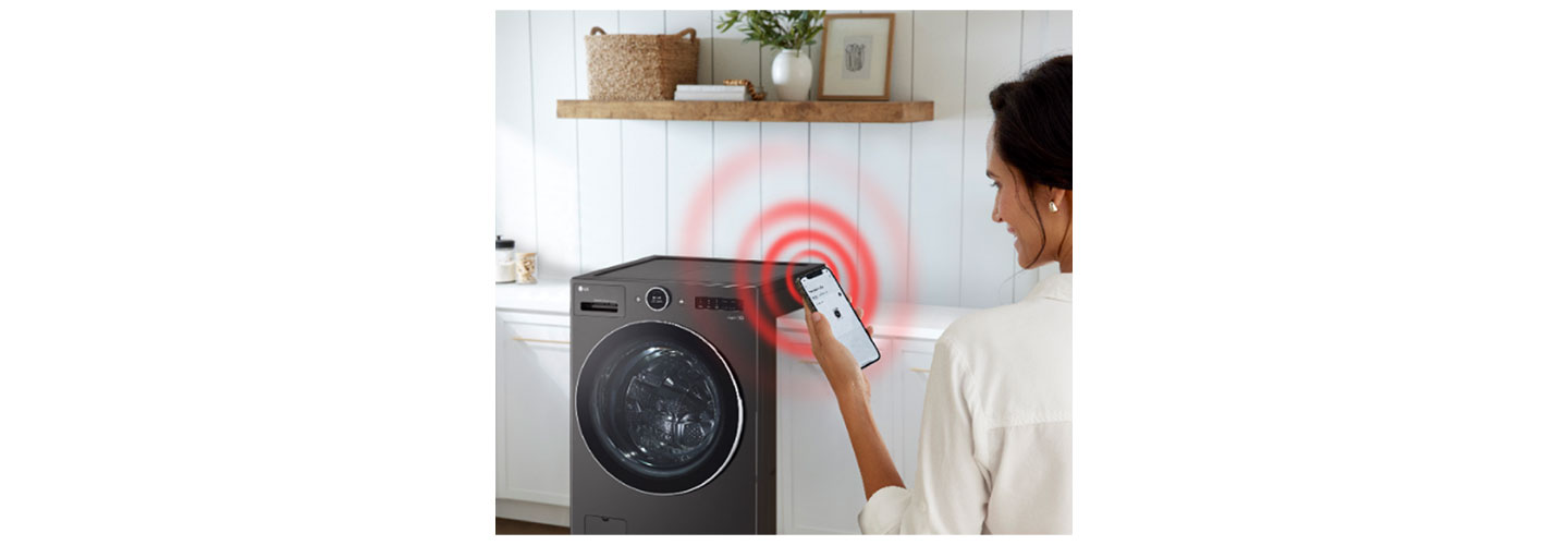 An image of a woman standing with her phone in front of the LG WashCombo with a ringing illustration coming from the phone