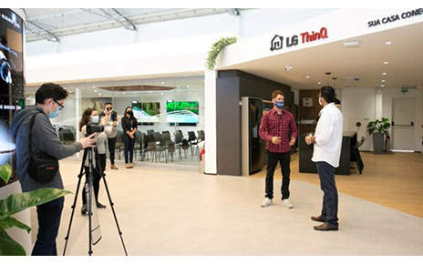 Two men discussing LG ThinQ at The LG Business Solution Center during filming.