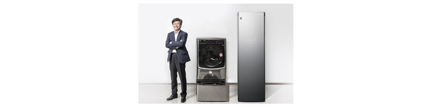 Dong-won Kim, Ph.D. Laboratory Leader of Living Appliance R&D Lab at LG, standing proudly next to the LG TWINWash and LG Styler appliances he invented.
