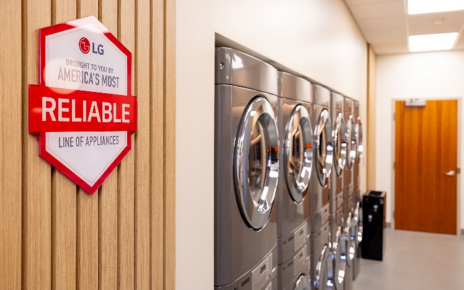 LG washers and dryers line the wall, with a plaque featuring the message, "Brought to you by America's Most Reliable Line of Appliances."