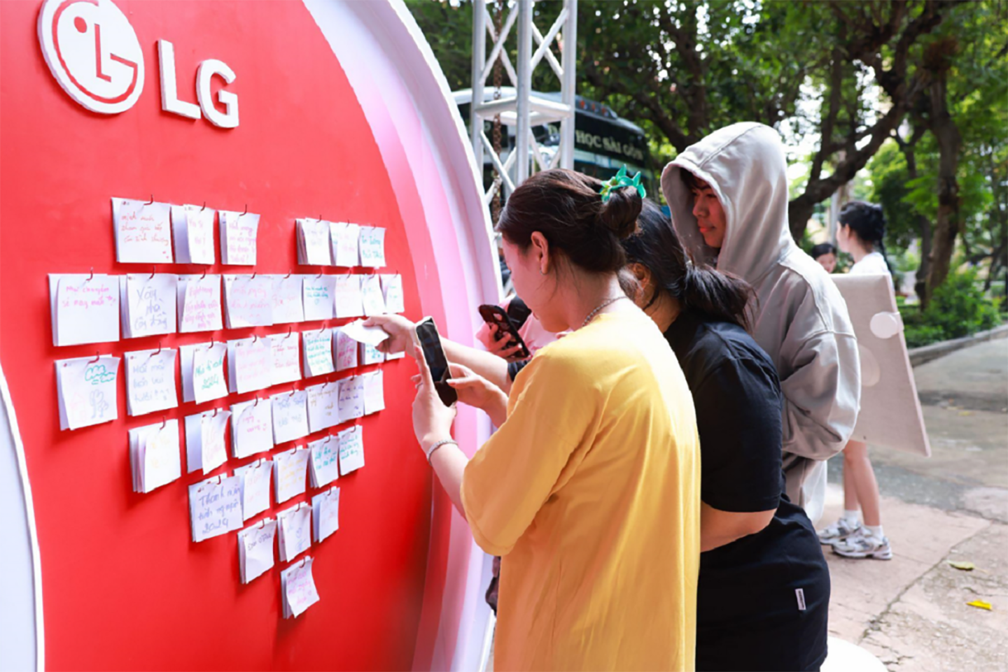 A picture of three students participating in an event with sticky notes