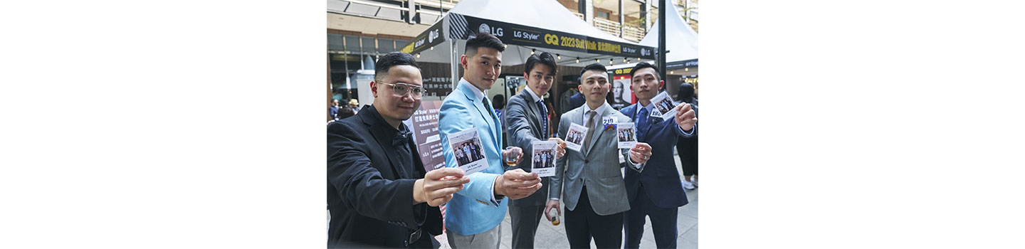 Five men posing with polaroid photos in their hands which was taken as an event at LG booth