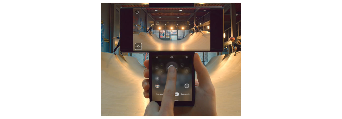 Someone uses LG WING's joystick feature in Swivel Mode to film two kids skateboarding on a vert ramp