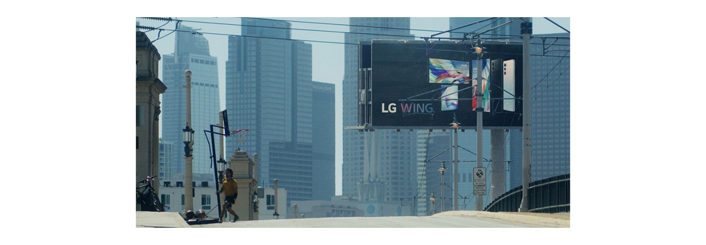 A billboard advertisement displaying the front and rear view of LG WING in Michael Bay’s upcoming film, Songbird 