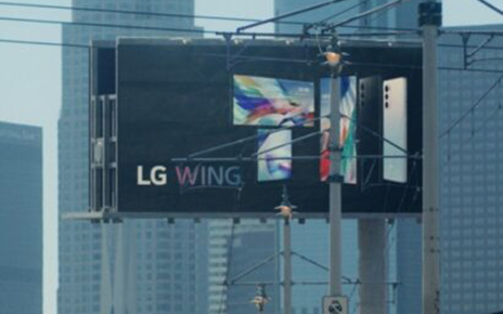 A billboard advertisement displaying the front and rear view of LG WING in Michael Bay’s upcoming film, Songbird 