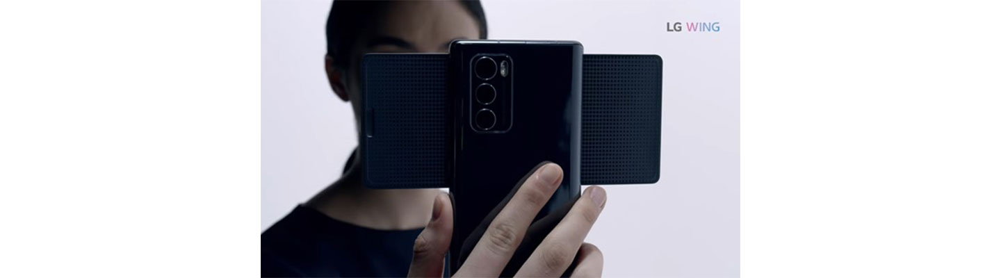 A person holds LG WING in Swivel Mode with the three rear camera lenses clearly seen