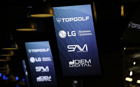 LG’s commercial displays show four brand logos including LG Electronics and Topgolf Entertainment Group on their screens.
