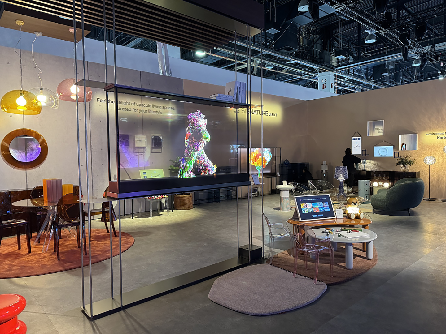 A picture of the showroom with Kartell products and two LG Signature OLED T's