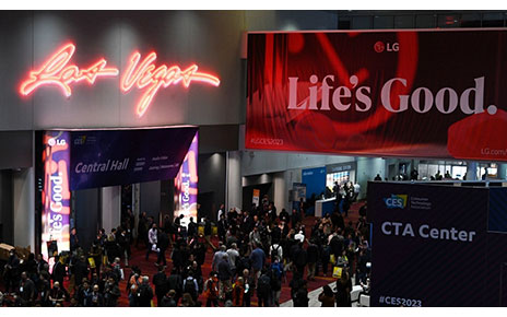 The entrance of LG booth at CES 2023 where a promotional LG poster is hanging from above