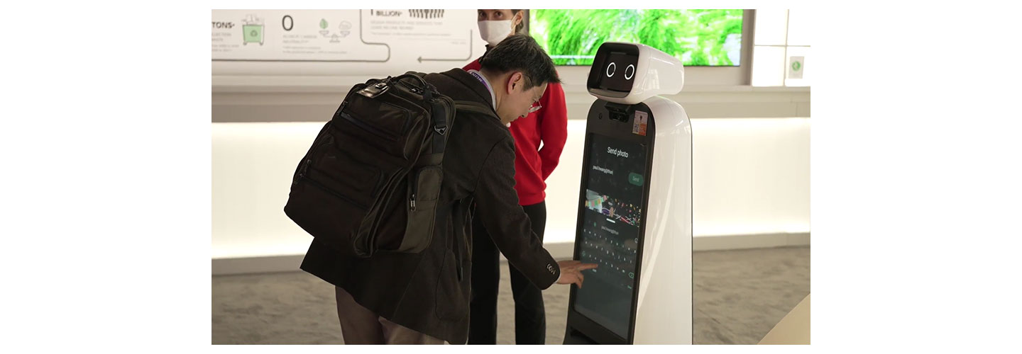 A visitor at LG Booth getting some help from LG CLOi GuideBot