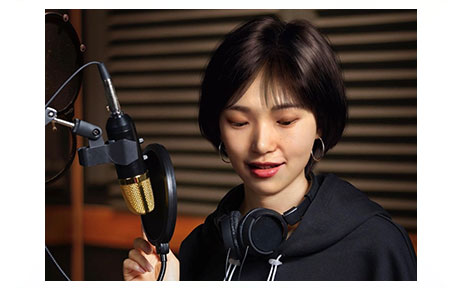 Virtual artist Reah Keem recording a song in the studio.