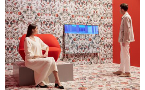 A man and women enjoying the artistic white and red Moooi space designed to display LG OLED Objet Collection Posé and LG PuriCare AeroFurniture in unique patterns and colors