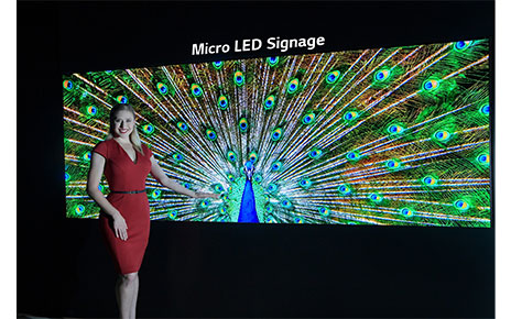 A model poses with the Micro LED signage.