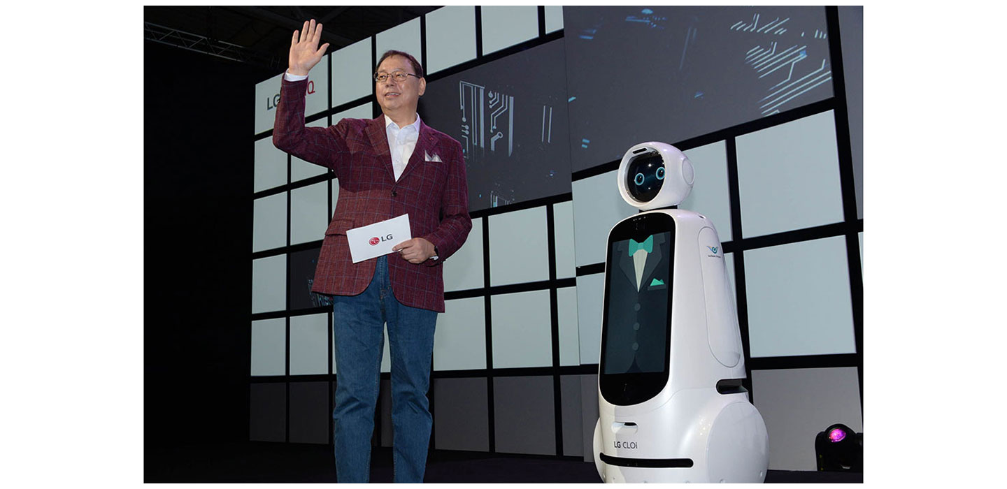 LG Electronics chief executive officer, Jo Seong-jin, stands right next to the LG CLOi robot.