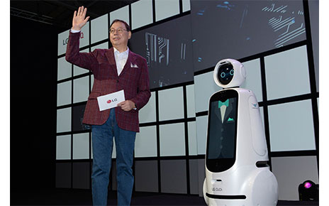 LG Electronics chief executive officer, Jo Seong-jin, stands right next to the LG CLOi robot.