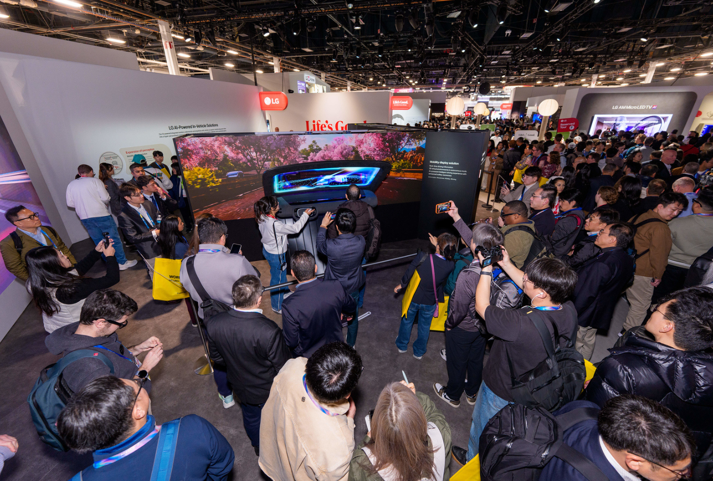 Visitors enjoy the Ride in Tune zone, with an AI-powered windshield screening a road with vivid flowers and trees.