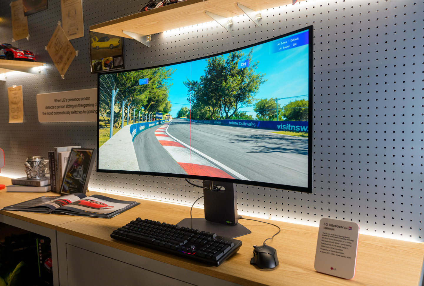 A curved UltraGearTM OLED Monitor displays vibrant road visuals through a desktop setup in the Entertainment in Tune zone.