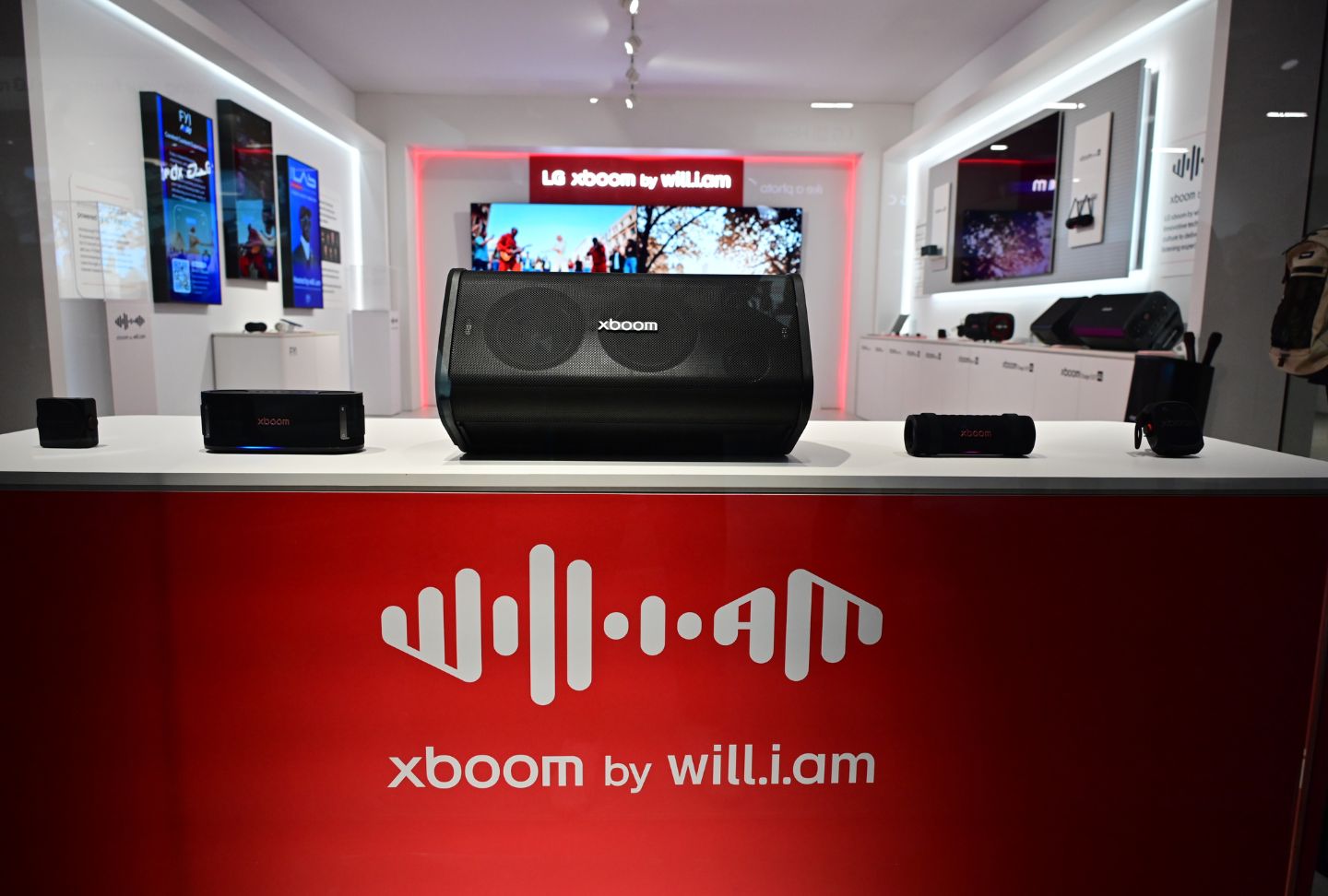 Various xboom audio products are displayed in a dedicated "xboom by will.i.am" area of the booth.