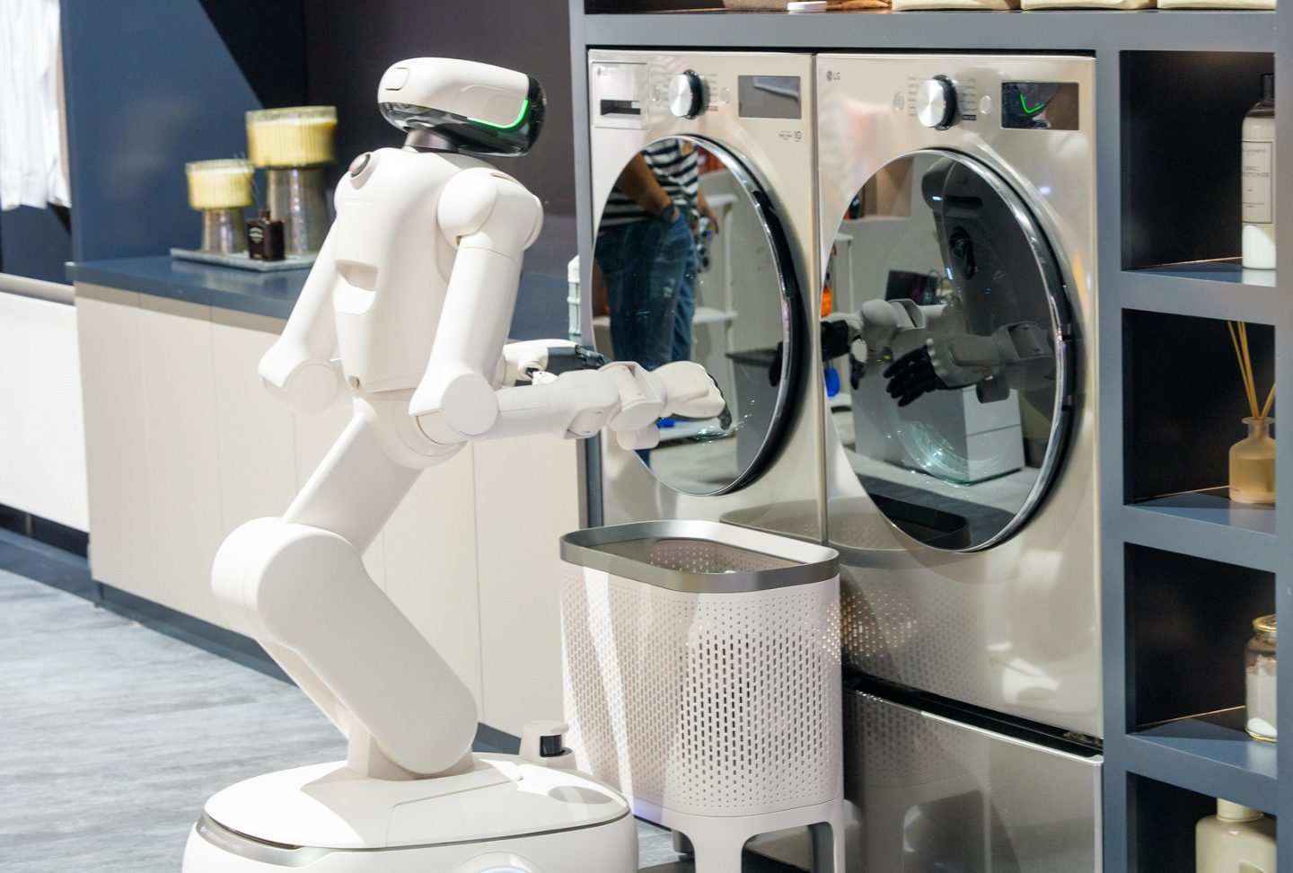 LG CLOiD™ is placing laundry in an LG washer in the Living in Tune zone.