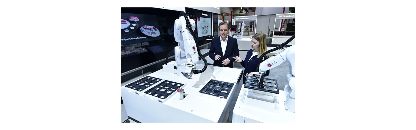 Models pose with the 6-axis robot utilizing Automated Guided Vehicle (AGV).