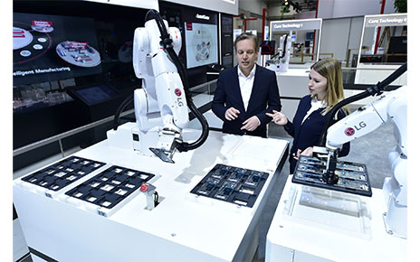 Models pose with the 6-axis robot utilizing Automated Guided Vehicle (AGV).