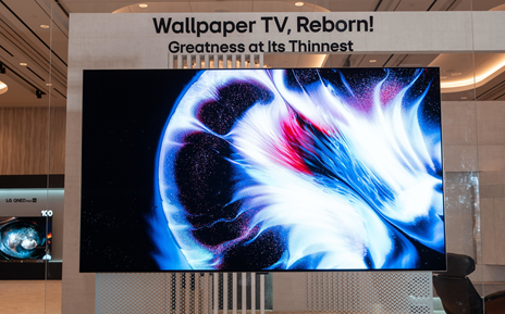 A bright abstract image is displayed on an LG OLED evo W6 Wallpaper TV.