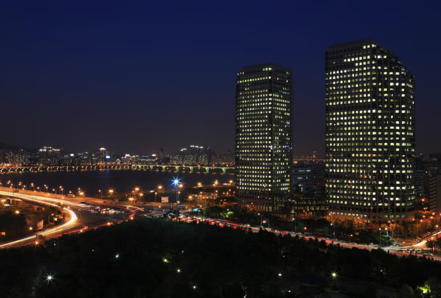 An aerial view displays a nighttime cityscape of the LG Twin Towers.