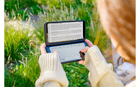 A woman holds the LG G8X ThinQ and the LG Dual Screen horizontally, with the Memo app on the Dual Screen and the LG Smart Keyboard on the main screen