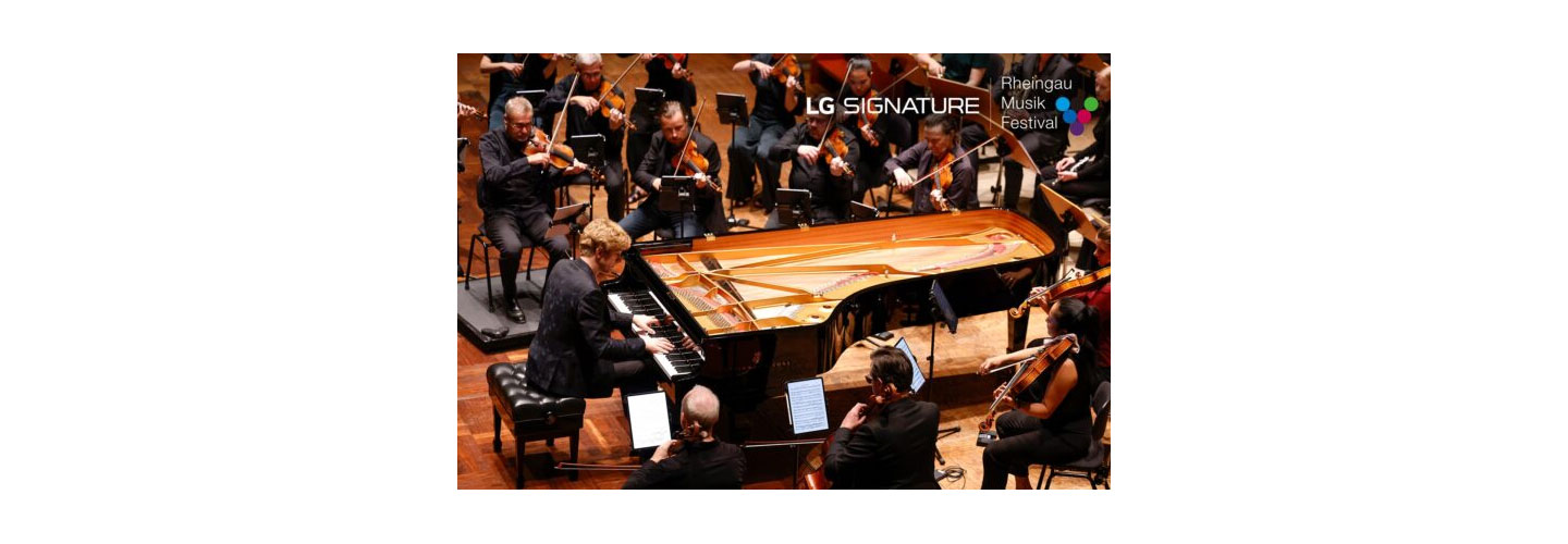 Pianist Jan Lisiecki performing with an orchestra at the Kurhaus Wiesbaden convention center for a charity concert LG SIGNATURE hosted