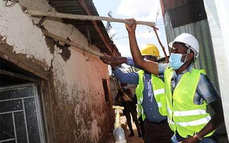 Ethiopian construction workers tearing down cracked walls for the Life’s Good: Hope Village campaign.