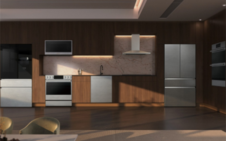 The LG SIGNATURE Smart InstaView™ refrigerator, LG SIGNATURE Oven Range, LG SIGNATURE dishwasher and new LG SIGNATURE refrigerator are displayed in a modern kitchen setting with dark wood cabinetry.